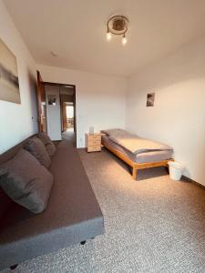 a living room with a couch and a bed at Ferienwohnung Bienenkorb in Selb