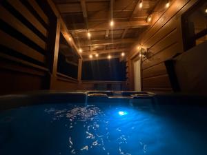 a hot tub in a dark room with lights at Getaway Cabin Loft Oasis Mountain View in Gatlinburg
