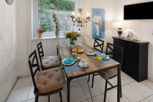 a dining room with a table and chairs with food on it at Ferienwohnung an der Dönche in Kassel +12 photos
