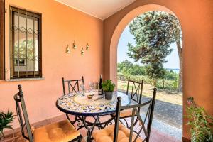 a dining room with a table and chairs on a patio at Villa Del Riccio in Magione
