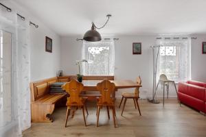 a living room with a wooden table and chairs at Heimelige Schwarzwaldwohnug Berg in Häusern +19 photos