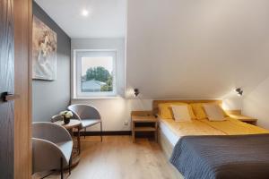 a bedroom with a bed and a table and a window at Heimelige Schwarzwaldwohnug Berg in Häusern