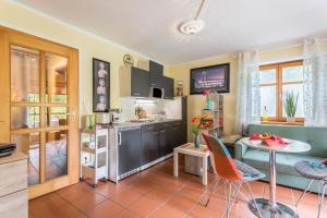 a kitchen with a table and chairs in a room at Ferienwohnung Chiemgau - erleben in Siegsdorf