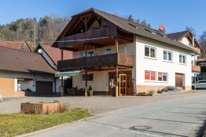 a large white house with a wooden roof at Obstgut Mit Herz Thomas Maier in Stockach
