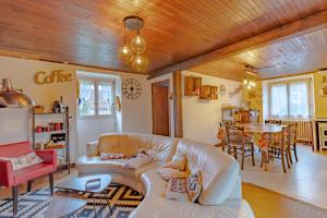 a living room with a white couch and a table at Les Gabernous in Tursac