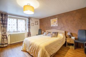 a bedroom with a bed and a window at Les Gabernous in Tursac