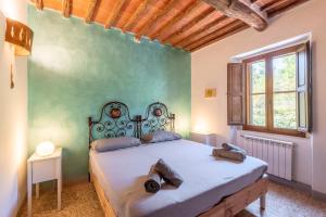 a bedroom with a bed and a green wall at Podere La Speranza in Chiusdino