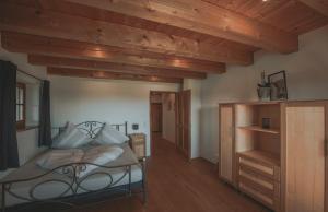 a bedroom with a bed with a wooden ceiling at Ferienhaus Kaiser in Aßling