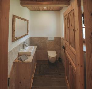 a bathroom with a sink and a toilet at Ferienhaus Kaiser in Aßling +35 photos