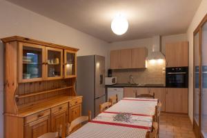a kitchen with a table and a table and chairs at Les Sources Gîte Sauvignon in Chambonas