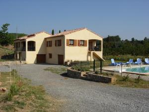 a house with a swimming pool in front of it at Les Sources Gîte Sauvignon in Chambonas