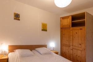 a bedroom with a bed with two white pillows at Les Sources Gîte Sauvignon in Chambonas +15 photos