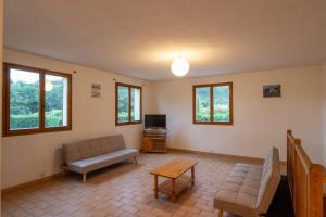 a living room with a couch and a table at Les Sources Gîte Sauvignon in Chambonas
