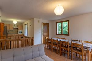 a dining room and kitchen with a table and chairs at Les Sources Gite Cabernet in Chambonas