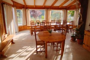 a large room with a wooden table and chairs at Les Planious in LʼÉpine
