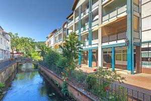 a building with a river in front of a building at Ferienwohnung Roswitha am Park in Bad Orb