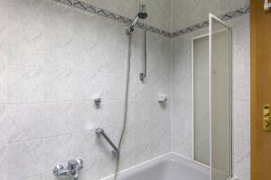 a shower with a glass door in a bathroom at Ferienwohnung Roswitha am Park in Bad Orb +14 photos