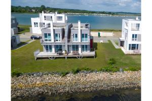 an aerial view of a large white house on the water at Schleivilla Kapitän James Cook2 in Kappeln