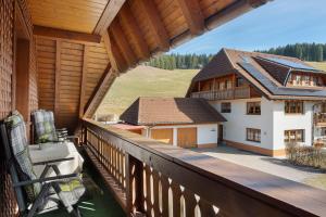 a balcony with a view of a house at Oberes Wirtshaus in Titisee-Neustadt