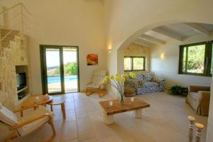a living room with a couch and a table at Villa Mataki Ideales Resort in Kefallonia