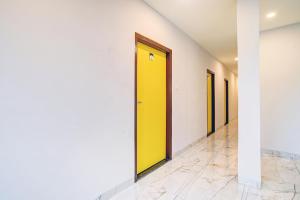 a hallway with a yellow door in a building at Townhouse Pine Tree in Indore
