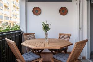 a wooden table on a balcony with two chairs at Experiencia Marina A107 in Torrox