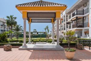 a gazebo in the courtyard of a building at Experiencia Marina A107 in Torrox