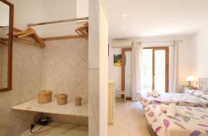 a bedroom with two beds and a living room at Ca Na Barbara in Santanyi +12 photos