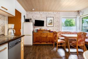 a kitchen and dining room with a table and a refrigerator at Ferienwohnung Caspersen in Viöl