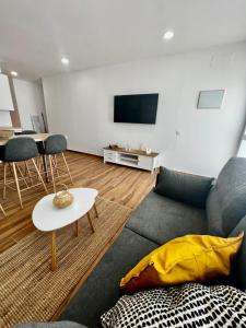a living room with a couch and a table at Amber L5 in Armeñime