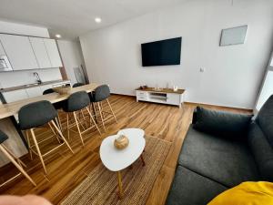 a living room with a couch and a table at Amber L5 in Armeñime