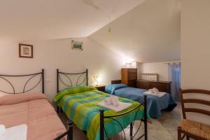 a bedroom with two beds and a mirror at Papà Giuseppe Il Fienile in Cortona +24 photos