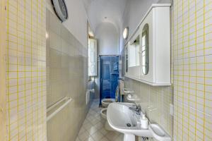 a bathroom with three sinks and two toilets at Luisa in Leuca +32 photos