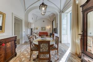 a dining room with a table and chairs and a couch at Luisa in Leuca
