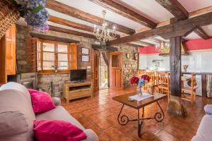 a living room with a couch and a table at Apartamento Juntana 1 in Villacarriedo