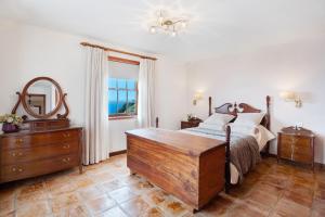 a bedroom with a bed and a dresser and a mirror at Casa 1700 Los Quemados in Los Quemados