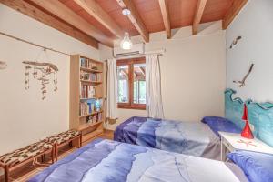 a bedroom with a blue bed and a book shelf at Can Om in Campos +19 photos