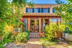 a home with a large glass door and trees at Can Om in Campos