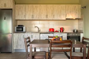 a kitchen with a table with a bowl of fruit on it at Zoi apartment in Kefallonia