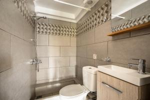 a bathroom with a toilet and a sink at Zoi apartment in Kefallonia +14 photos