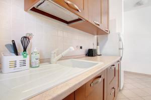 a kitchen with a white sink and a refrigerator at Casa Lierna in Lierna +11 photos