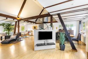 a living room with a large television in a loft at Ferienhaus Weitblick in Eslohe