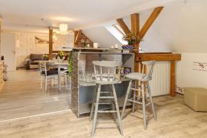 a kitchen and living room with a counter and stools at Lieblingsgast in Klötze