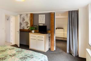 a bedroom with a bed and a desk with a television at Lieblingsgast in Klötze