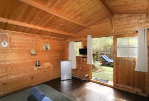 a living room with wooden walls and a large window at Le Chalet De La Plage in Coti-Chiavari