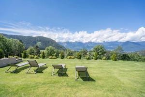 a group of chairs and tables on a grass field at Gasserhof - Chalet B in Meltina