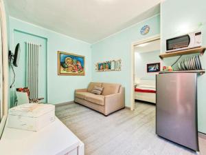 a living room with a refrigerator and a couch at Villa Galatea La Conchiglia in Capoliveri