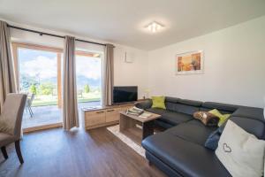 a living room with a couch and a television at Gasserhof - Chalet B in Meltina