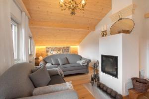 a living room with a couch and a fireplace at Haus Alpenveilchen - Appartement 4 in Schönau am Königssee