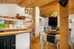 a kitchen and dining room with a table and chairs at Haus Alpenveilchen - Appartement 4 in Schönau am Königssee